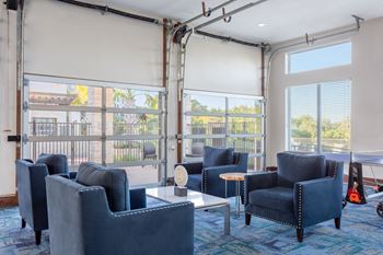 clubhouse with blue chairs and firehouse style garage doors